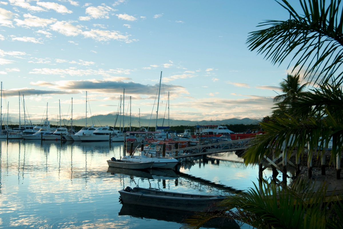 Boats moored along the jetties at Port Denarau marina in the evening light